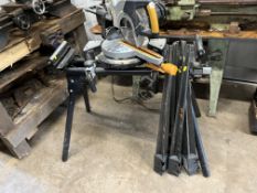 AN EVOLUTION SLIDING COMPOUND MITRE SAW, on folding stand with a 10in blade and five soil post