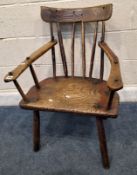 AN ELM PRIMITIVE COMB BACK CHAIR, with a curved top and armrests, raised on four splayed legs, width
