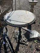 A MODERN CAST IRON GARDEN TABLE, with a 52cm top, above pedestal support with foliate details and