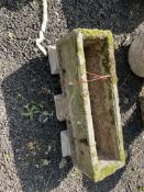A RECTANGULAR CONCRETE PLANTER, with three supports, 65cm long