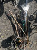 A COLLECTION OF GARDEN TOOLS, including tree loppers, forks, rakes, spades, etc (15+)