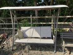 A METAL FRAMED SWINGING GARDEN BENCH, with fabric shade and seats 190cm wide, Condition Report: