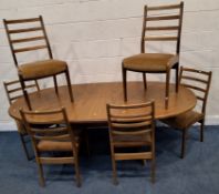 A MID-CENTURY G PLAN TEAK OVAL EXTENDING DINING TABLE, with a single fold-out leaf, extended