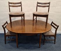 A MID-CENTURY TEAK EXTENDING DINING TABLE, with a single fold-out leaf, raised on cylindrical