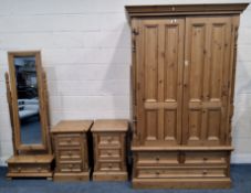 A LARGE PINE DOUBLE DOOR WARDROBE, with three assorted drawers, width 130cm x depth 67cm x height