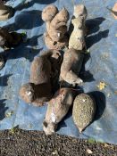 A COLLECTION OF CONCRETE GARDEN FIGURES including otters, squirrels, dog, cats, a badger, etc (7)