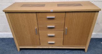A MODERN LIGHT OAK AND BEECH SIDEBOARD, fitted with two cupboard doors, flanking four drawers, width