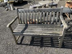 A HARDWOOD GARDEN BENCH, with slatted seat and back 122cm wide, Condition Report: sturdy but
