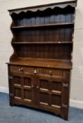 A LATE 20TH CENTURY OAK WALL UNIT, the three tier plate rack atop a base with two drawers over