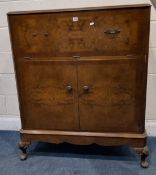 A 20TH CENTURY BURR WALNUT COCKTAIL CABINET, with an articulated fall front door, over double