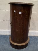 A 19TH CENTURY MAHOGANY CYLINDRICAL POT CUPBOARD, with a dished top and a single cupboard door,