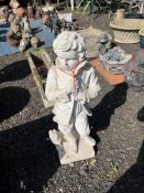 A CONCRETE GARDEN FIGURE, in the form of a boy leaning against a tree stump, 78cm tall