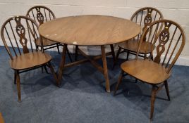 LUCIAN ERCOLANI, AN ERCOL MID-CENTURY ELM AND BEECH DROP LEAF TABLE, raised on splayed legs,