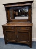AN EARLY 20TH CENTURY OAK MIRROR BACK SIDEBOARD, with a bevelled mirror plate, flanked by barley
