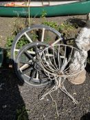 A WIRE FRAMED PEDESTAL PLANTING BASKET, 56cm high, one plastic and one concrete cart wheel (3)
