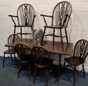 A 20TH CENTURY OAK DINING TABLE, raised on trestle-style legs, united by a stretcher, width 153cm