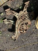 A PAIR OF EARLY 20th CENTURY CAST IRON BENCH ENDS, with pierced fretwood scrolled details, Condition