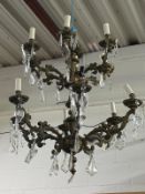 A BRASS TWO-TIER CHANDELIER, with twelve branches and clear glass droplets, approximate height 82cm,
