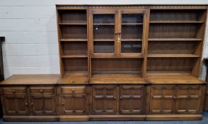 AN ERCOL MURAL WALL UNIT, fitted with an arrangement of shelves, drawers, cupboard doors, double