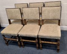 A SET OF SIX OAK FRAMED DINING CHAIRS, with oatmeal upholstery, raised on block and turned legs,