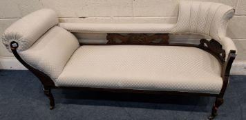 AN EDWARDIAN CHAISE LONGUE, with a scrolled end and a bow top style backrest, raised on cabriole