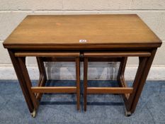 A.H. MCINTOSH & CO LTD, KIRKCALDY, SCOTLAND, A MID CENTURY TEAK TRIFORM NEST OF TABLES, the