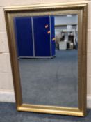 A GILT WOOD RECTANGULAR BEVELLED EDGE WALL MIRROR, 106cm x 76cm, condition report: general signs