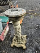 A CONCRETE BASED SUNDIAL, with foliate detail and a grey metal dial to top, 84cm high