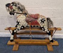 A 20TH CENTURY DAPPLE PAINTED CARVED TIMBER ROCKING HORSE, with real horse hair mane and tail,