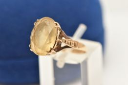 A 9CT YELLOW GOLD 1970S CITRINE SINGLE STONE RING, the oval-shaped mixed cut Citrine, within a