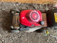 A HONDA IZY PETROL LAWN MOWER, with grassbox (engine pulls freely but hasn't been started)