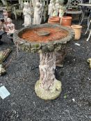 A CONCRETE SUNDIAL, with a tree stump effect base, rabbits at the footing and a flat bowl, 71cm