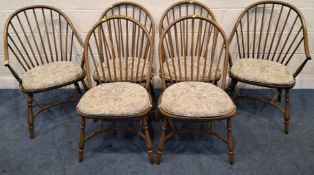 A SET OF SIX ERCOL ELM AND BEECH CHAIRS, including two armchairs, with spindle back, raised on