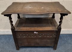 AN EARLY 20TH CENTURY OAK MONKS BENCH, with a tilting surface/backrest, barley twist supports, and a