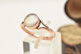 A ROSE METAL MOONSTONE CABOCHON SET RING, of a circular form, milgrain collet set with a moonstone