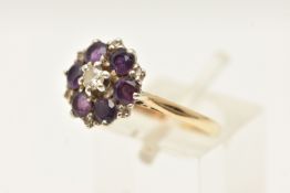 A 9CT GOLD AMETHYST AND DIAMOND CLUSTER RING, set with a round brilliant cut diamond, bordered by