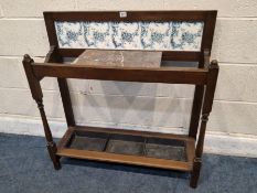 AN EARLY 20TH CENTURY UMBRELLA / STICK STAND, with a tiled back, a rectangular marble top, raised on