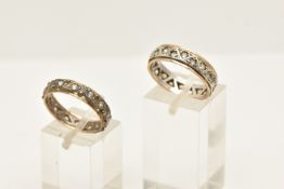 TWO YELLOW AND WHITE METAL ETERNITY RINGS, each eternity ring set with colourless paste, one ring