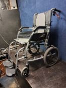 A KARMA ERGO LITE 2 FOLDING WHEEL CHAIR, with two footrests