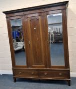 CHRISTOPHER PRATT AND SONS, AN EDWARDIAN MAHOGANY COMPACTUM WARDROBE, fitted with two bevelled glass