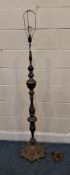 A BRASS STANDARD LAMP, with intricate scrolled and foliate details, raised on six small feet, height