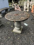 A CONCRETE GARDEN TABLE, with embossed foliate detail to 67cm diameter top, and a later base