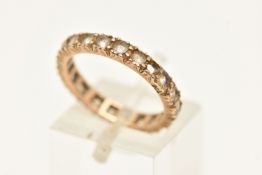 A YELLOW METAL FULL SET ETERNITY RING, set with colourless spinel (one stone is missing), stamped