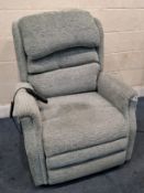 A BLUE UPHOLSTERED ELECTRIC RISE AND RECLINE ARMCHAIR, with adjustable headrest and lumbar