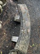 A CURVED CONCRETE GARDEN BENCH, with scrolled bases, width 135cm