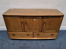 LUCIAN ERCOLANI, AN ERCOL MID-CENTURY ELM WINDSOR SIDEBOARD, model number 468, fitted with three