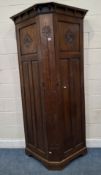 AN EARLY 20TH CENTURY OAK HALL ROBE, with double cupboard doors, floral carved details, width