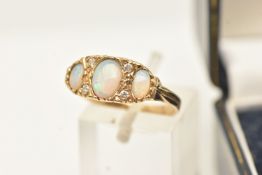A 9CT YELLOW GOLD GEM SET RING, three oval opals accented with four round brilliant cut diamonds,