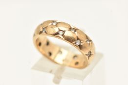 A 9CT YELLOW GOLD BAND RING, star set spinel's repeated over the band, approximate width 5mm,