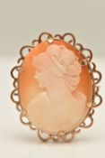 A 9CT GOLD CAMEO BROOCH, an oval shell cameo depicting a lady in profile, set in a yellow gold